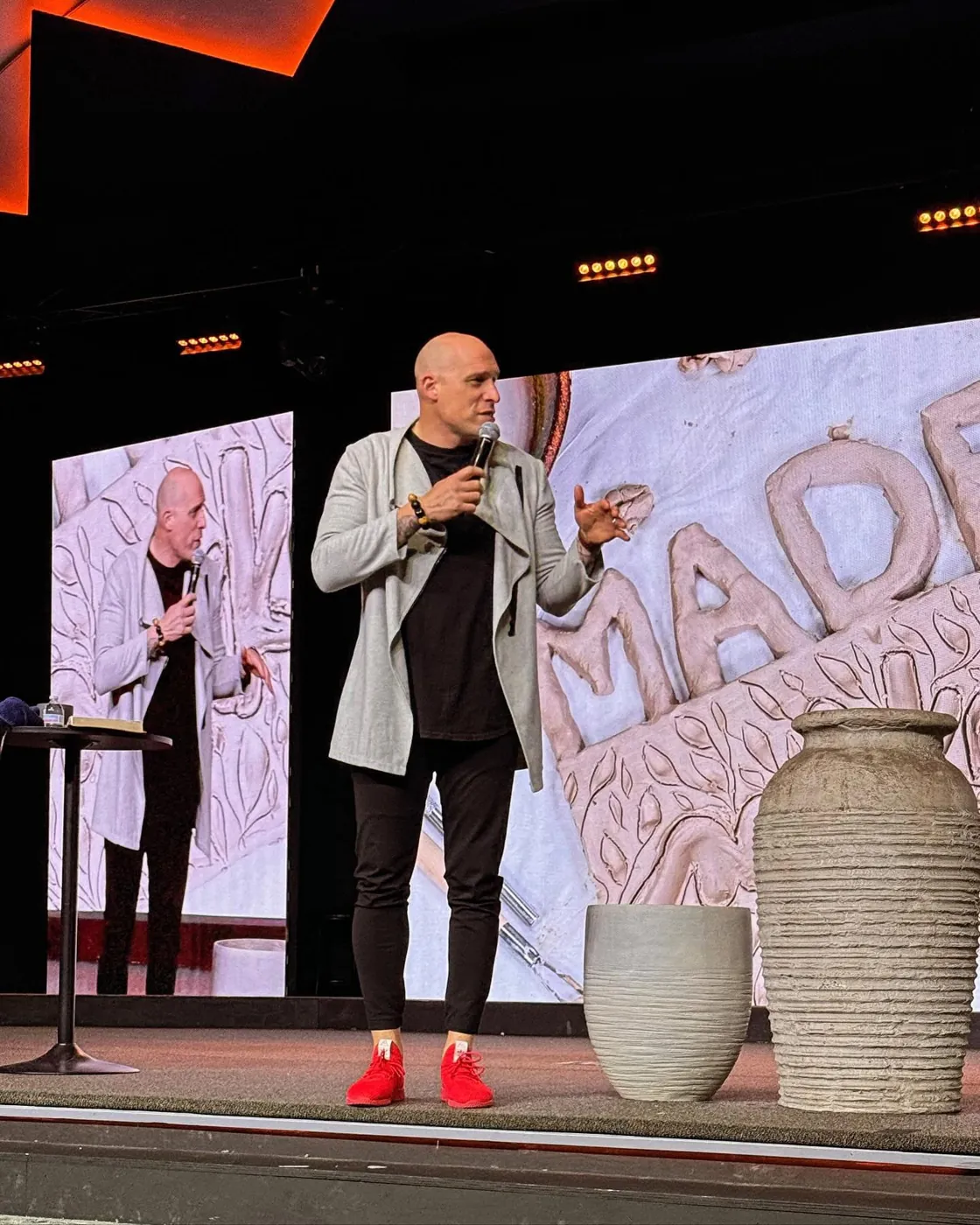 Speaker on a church stage in front of LED video walls, from an FM Tech LED video wall project