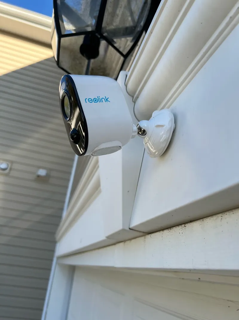 Exterior residential surveillance camera installed at an entrance